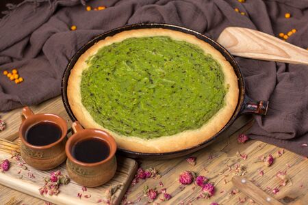 Still life - avocado pie in a frying pan on a wooden tableの写真素材