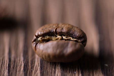 Grain of coffee close-up on a wooden backgroundの写真素材
