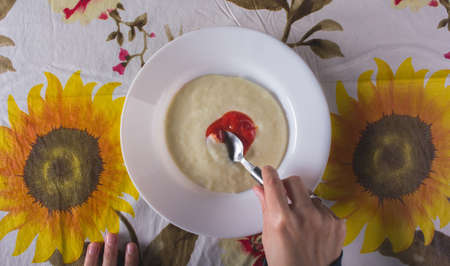 Mashed potatoes with ketchup on a table with a tablecloth- top viewの写真素材