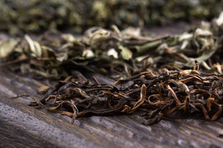 Dry leaves of different types of tea on a wooden backgroundの写真素材