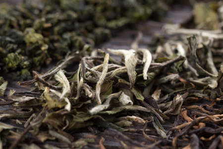 Dry leaves of different types of tea on a wooden backgroundの写真素材