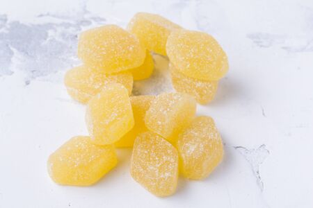 Candied fruit jelly. Yellow marmalade on a white backgroundの写真素材