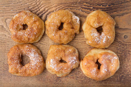 sugary donut on a wooden background, fastfoodの写真素材