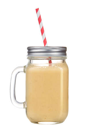Healthy refreshing fruit smoothie with straw in a jar mug isolated on white. isolated.の写真素材