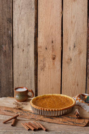 Fresh Homemade Pumpkin Pie made for Thanksgiving. Pie on a wooden background. Rustic.の写真素材