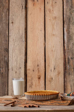 Fresh Homemade Pumpkin Pie made for Thanksgiving. Pie on a wooden background. Rustic.の写真素材