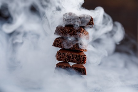Porous chocolate in stack on a black background closeup. A slide of porous chocolate on a dark background.の写真素材