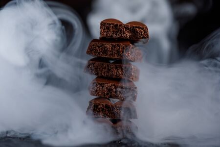 Porous chocolate in stack on a black background closeup. A slide of porous chocolate on a dark background.の写真素材