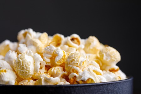 Fresh inviting popcorn in a ceramic bowl. Side view.の写真素材