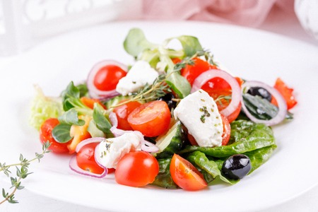 Appetizing and tempting Greek salad with micro greenery. Close-up.の写真素材
