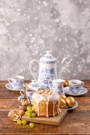 Vertical easter still life. A festive table with a home Easter cake, an ancient tea or coffee...