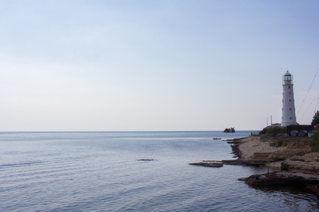 Stunning views of the sea and a lighthouse located on the coastal strip. Landscape.の写真素材