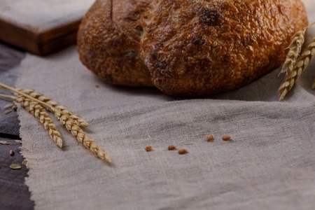 Craft bread close up. The concept of healthy food and traditional bakery. Rustic.の写真素材
