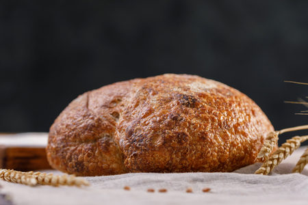 Craft bread close up on a dark background. The concept of healthy food and traditional bakery. Rustic.の写真素材
