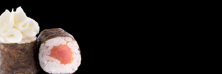 Classic sushi roll. Sushi at black background.Japanese seafood sushi , roll a white background. Close-up. Banner.の写真素材
