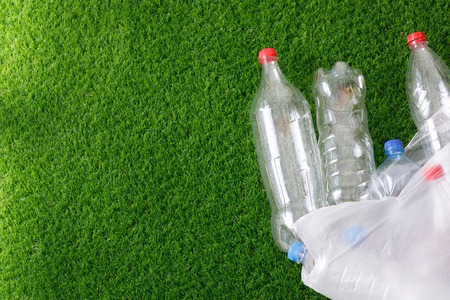 The concept of recycling plastic and environmental protection. Pet preforms for plastic bottles on...