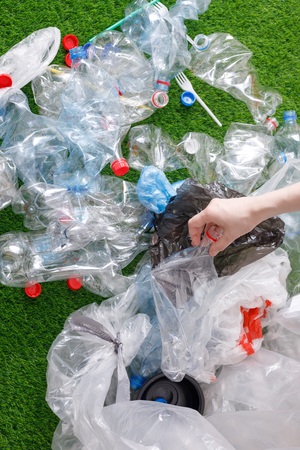 The concept of recycling plastic and environmental protection. Pet preforms for plastic bottles on...