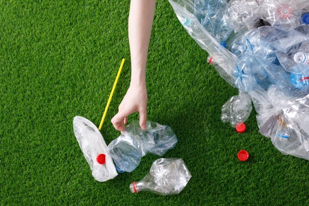 The concept of recycling plastic and environmental protection. Pet preforms for plastic bottles on...