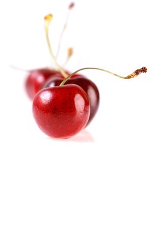 Fresh cherries on white background. Juicy summer berry close-up.Isolatedの写真素材