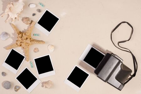 Empty photos and camera on a textural background. The concept of preserving memories. Starfish and...