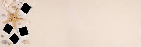 Empty photos and camera on a textural background. The concept of preserving memories. Starfish and...