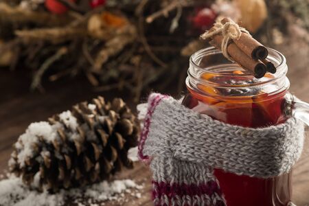 Fragrant drink of Christmas mulled wine with oranges and spices on a wooden background. Selective focus. Copy space Close-up.の写真素材