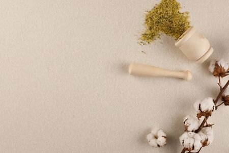 White cotton flowers on a colored background. Natural pharmacy, natural cosmetics. Copy space. Flat lay.の写真素材