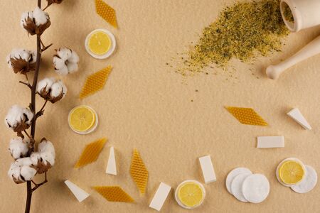 White cotton flowers on a colored background. Natural pharmacy, natural cosmetics. Copy space. Flat lay.の写真素材