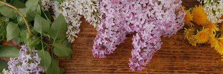 The decor of flowers on the background of vintage wooden planks. Vintage background with flowers of...