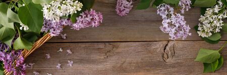 Plate and decor of flowers on the background of vintage wooden planks.Vintage background with lilac flowers and place under the text. View from above. Flat lay. Cutlery. Vintage.の写真素材