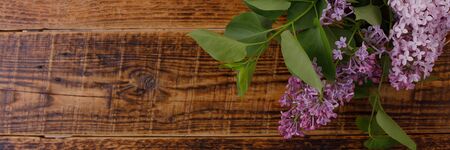 Decor of flowers on the background of vintage wooden planks.Vintage background with lilac flowers...