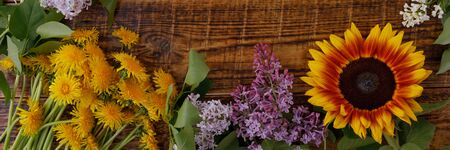 The decor of flowers on the background of vintage wooden planks. Vintage background with flowers of...