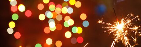 beautiful sparklers on the background of a garland. beautiful banner for the New Year. Happy.の写真素材