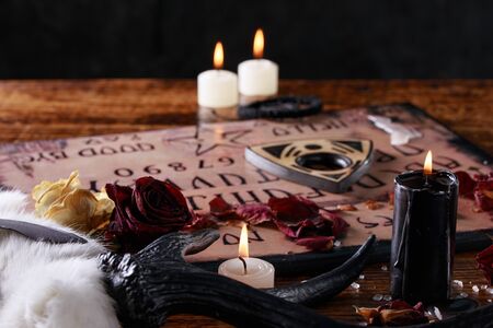 Talking board and planchette, also known as Ouija board, used for communicating with the dead and...