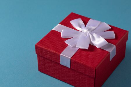 Valentine's Day celebration concept. A nice gift from a loved one. Box with a bow on a gentle blue background. Copy space. Flat lay.の写真素材