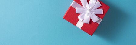 Valentine's Day celebration concept. A nice gift from a loved one. Box with a bow on a gentle blue...