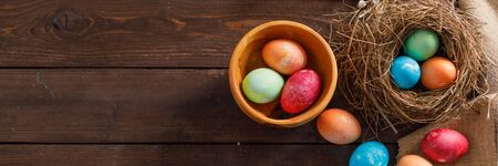 Still life of easter eggs in a bird's nest on a wooden background. Rustic. Easter celebration...