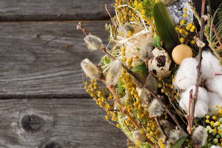 Wreath of dried twigs and flowers on a wooden background. Natural decoration. Celebration concept....