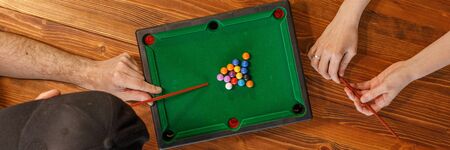 Young people play table billiards. Friendship and fun concept. Among friends and they are in a good...