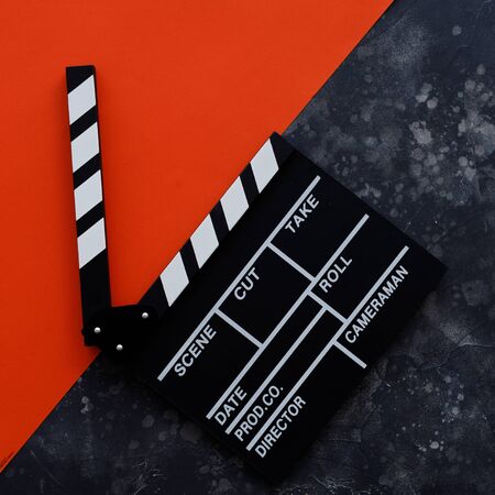 Filmmaking concept. Movie Clapperboard. Cinema begins with movie clappers. Top view. Copy space. Place for your text.の写真素材