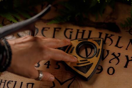 Mystic ritual and candles. Devil's board concept, black magic or fortune telling rite with occult and esoteric symbols. Mystical rituals and occult sciences.の写真素材