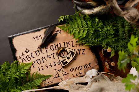 Mystic ritual and candles. Devil's board concept, black magic or fortune telling rite with occult and esoteric symbols. Mystical rituals and occult sciences.の写真素材