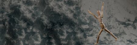 Puppet in the hands of puppeteer walks on isolated, background. Object on a texture background.