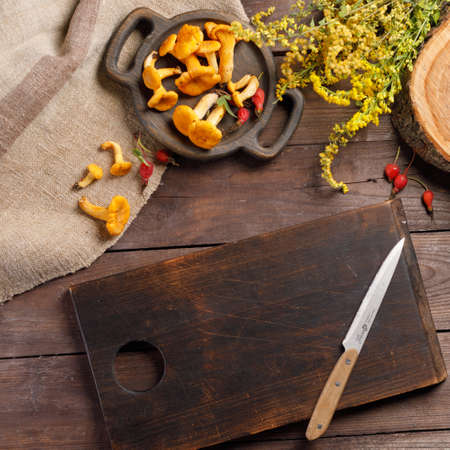 Autumn harvest of mushrooms on vintage rustic wooden background. Rustic kitchen table. Flat lay top, top view. Layout with free text space.の写真素材
