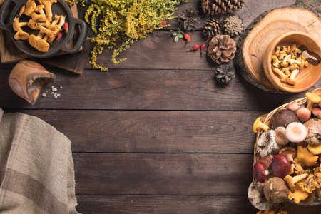 Autumn harvest of mushrooms on vintage rustic wooden background. Rustic kitchen table. Flat lay top,...