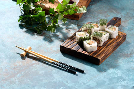 Unusual composition of rolls. Delicious food. A portion of rolls with an unusual filling. Asian delivery food. Sushi restaurant poster of Japanese food.の写真素材