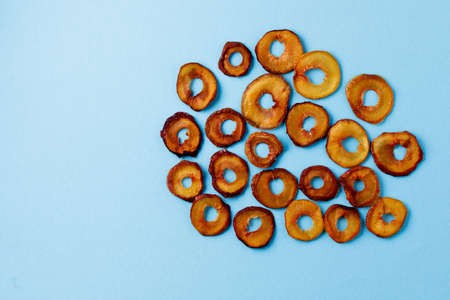 slices of dried plum on a blue background. dried fruits. eco.top view.の写真素材