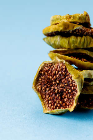slices of dried figs on a blue background. dried fruits. eco. macro.