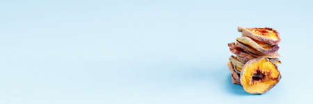 slices of dried peach on a blue background. dried fruits. eco. macro.