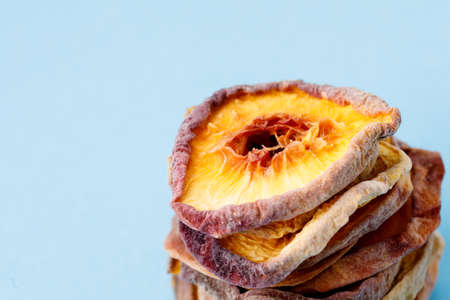slices of dried peach on a blue background. dried fruits. eco. macro.の写真素材